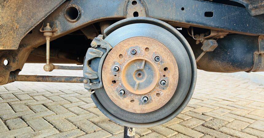 Brake disc, hub and caliper on a vehicle with the wheel removed