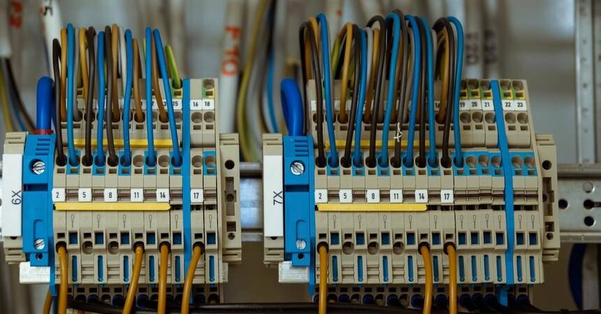 Terminal blocks and colour-coded wiring inside an electrical distribution panel