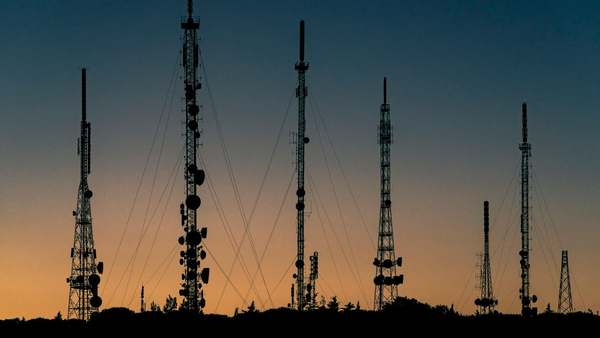 Radio masts against a sunset sky