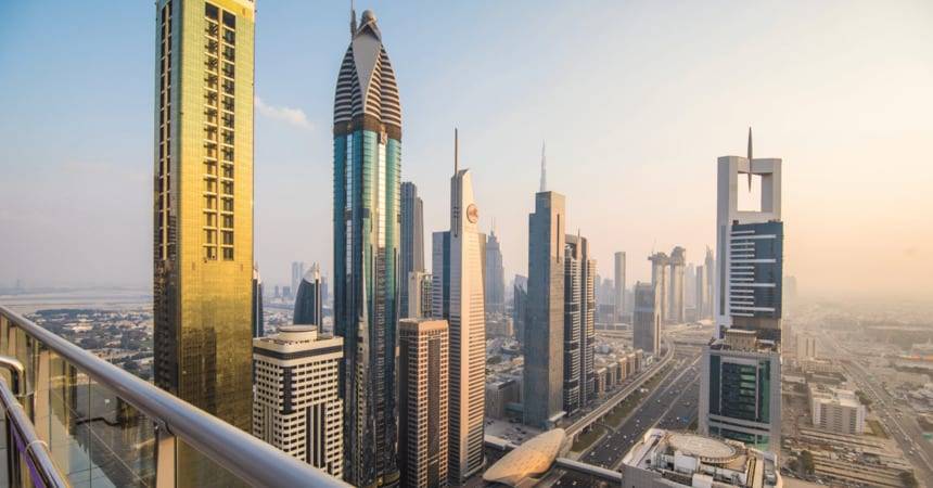 Dubai skyline of high-rise towers seen from a balcony at dusk